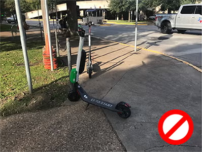 scooter parked on a curb cut