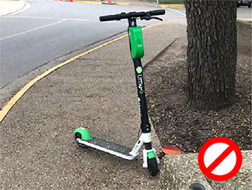 scooter parked halfway across sidewalk