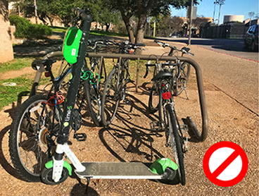 scooter parked behind a bike rack